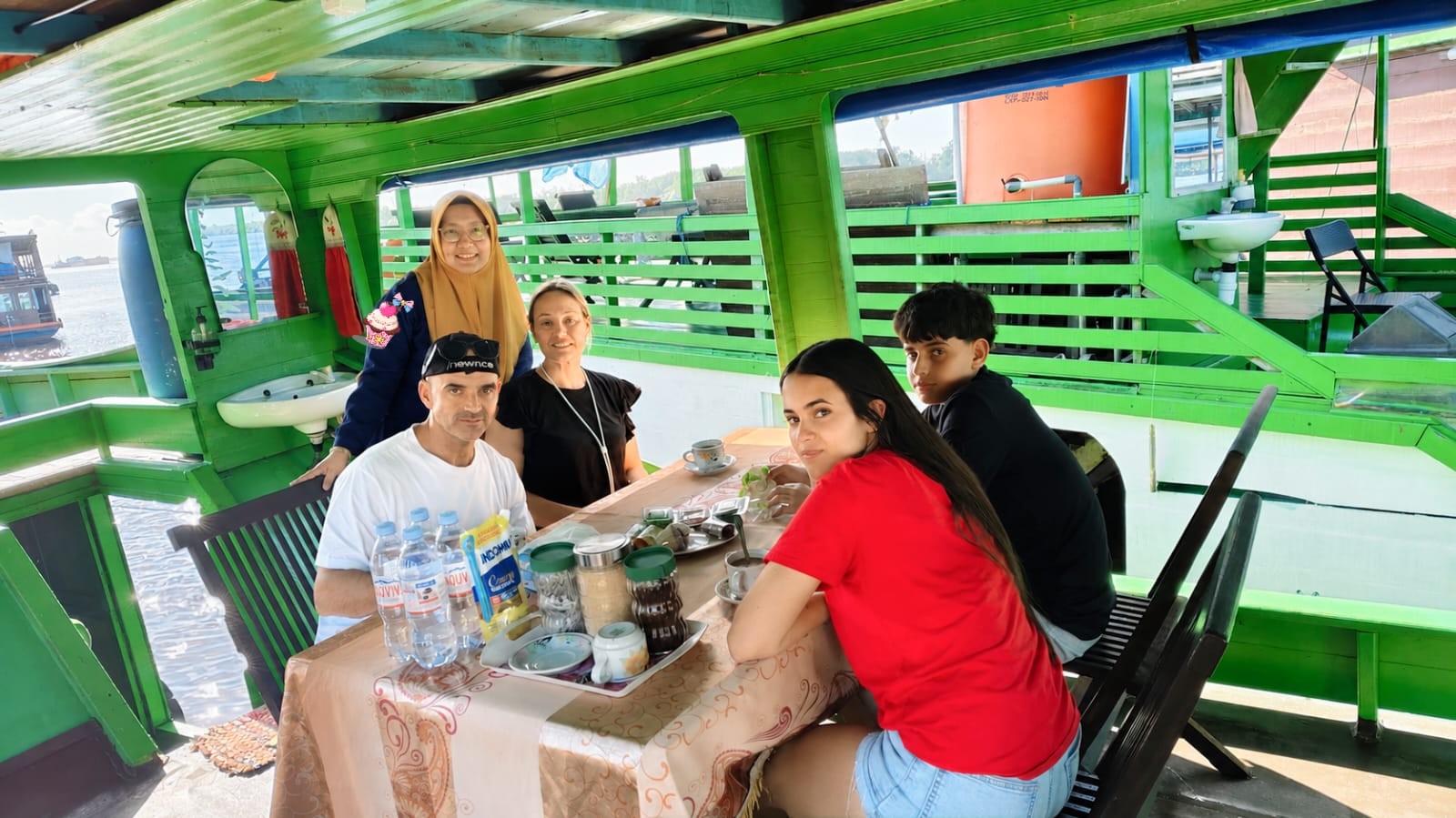 Guests bonding with the friendly local crew and guide aboard the klotok at Kumai.