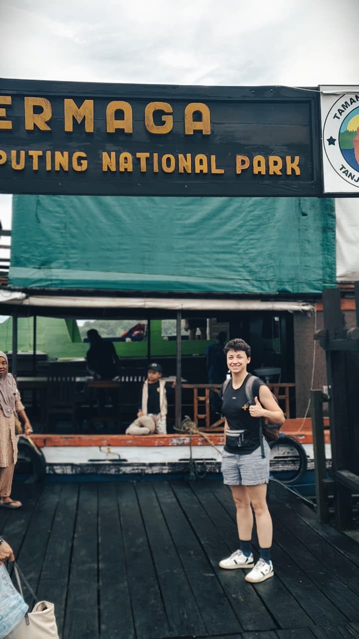 Young guest proudly posing at the Tanjung Puting National Park harbor dock.