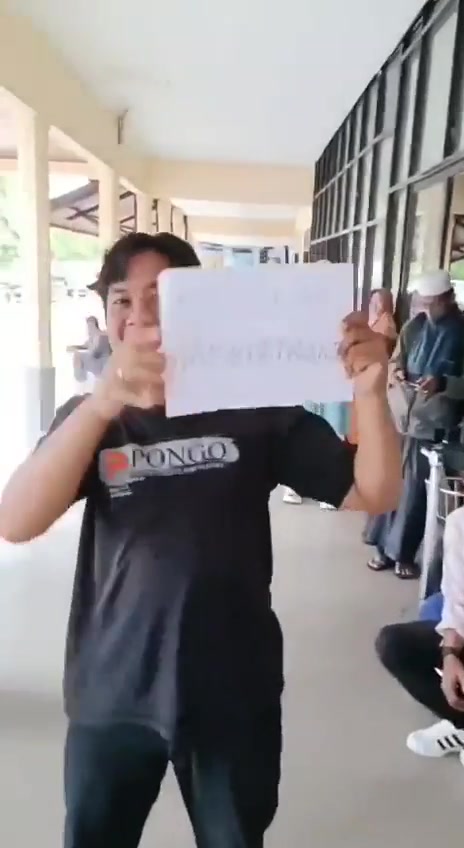 Your Orangutan Family Tour guide greeting guests with a welcome sign at Pangkalan Bun airport.